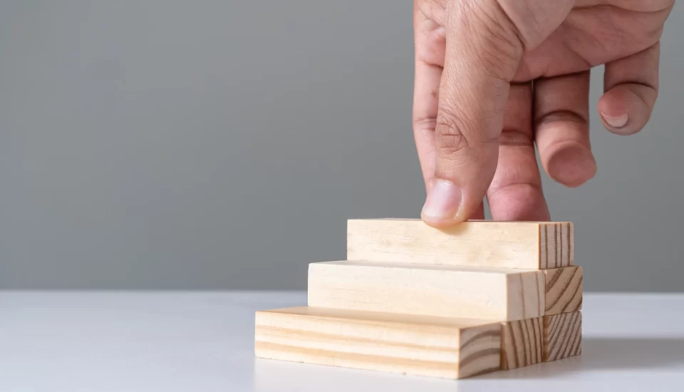 hand-arranging-wood-block-stacking-as-step-stair